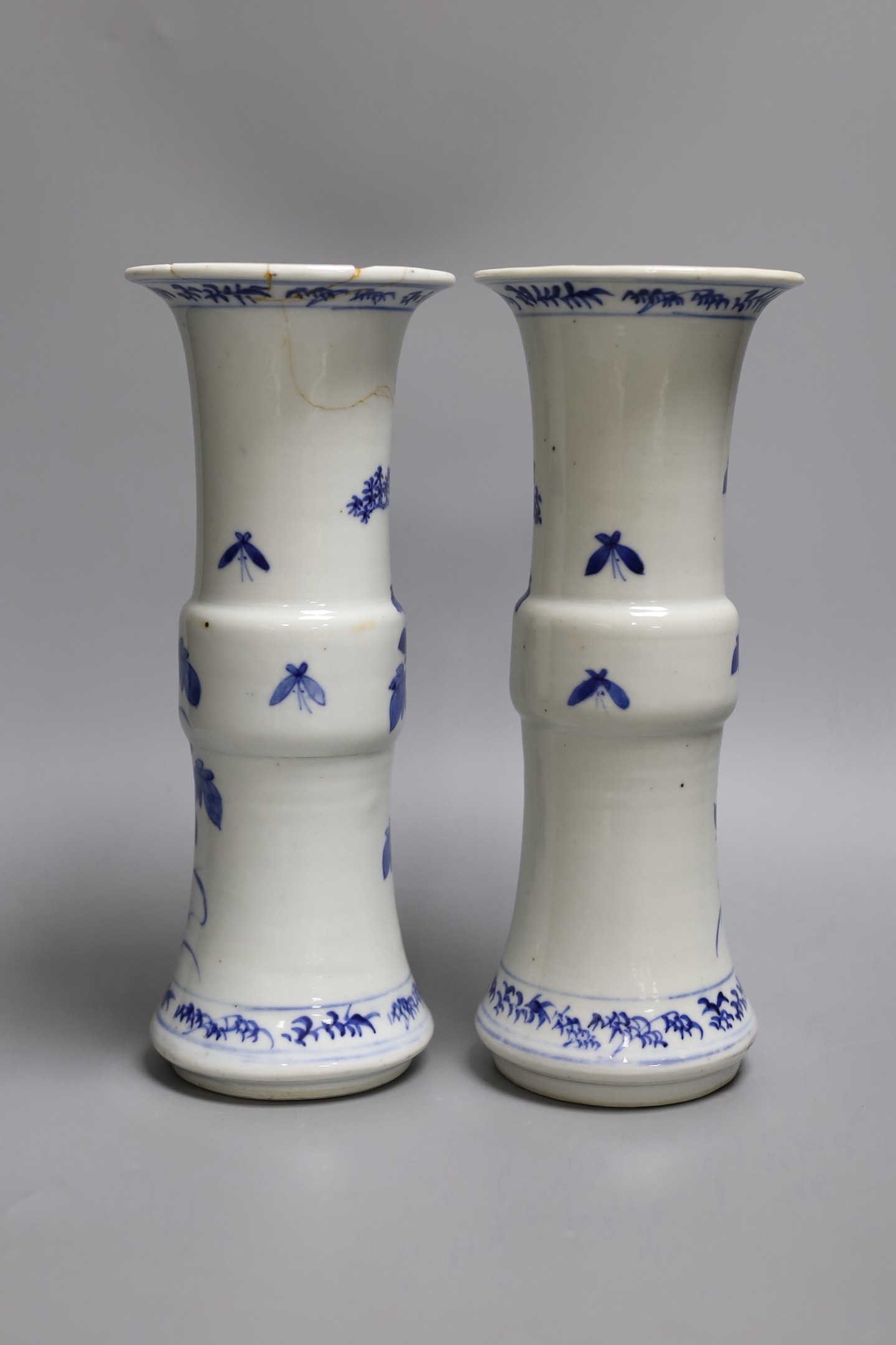A pair of 19th century Chinese blue and white 'rockwork, birds and flowers' gu vases, 26cm